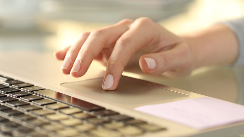 person using laptop trackpad