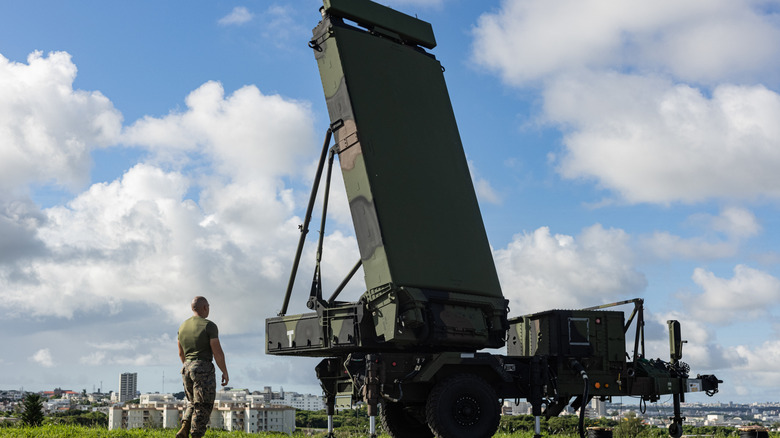 Soldier standing next to a deployed Northrop Grumman AN/TPS-80 Ground/Air Task Oriented Radar (G/ATOR)