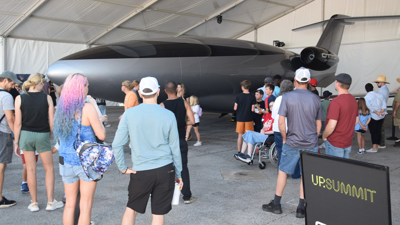 visitors inspect life sized phantom 3500 model at a summit