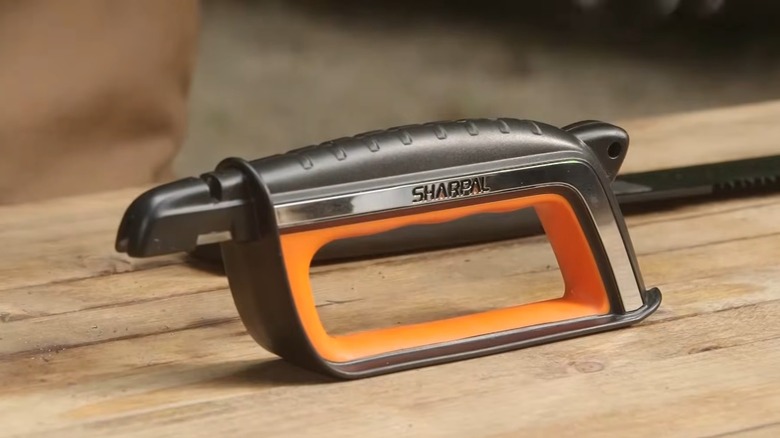 The SHARPAL 103N All-in-1 Knife Garden Tool Lawn Mower Blade Sharpener on a wooden table