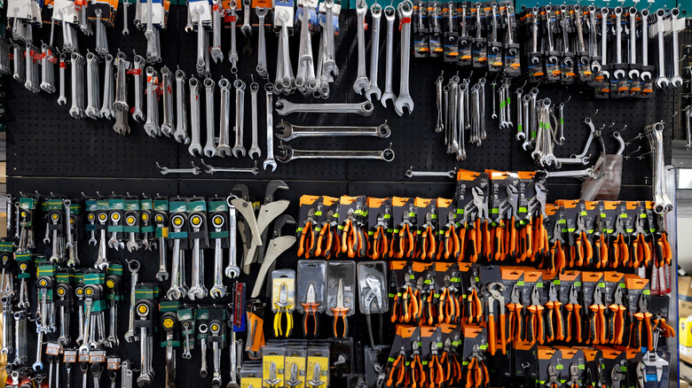A selection of tools on a wall at an unknown hardware store