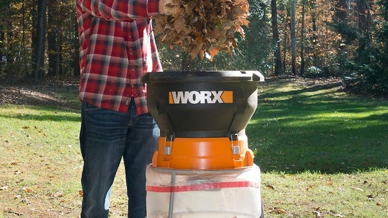 Person disposing of leaves in WORX leaf mulcher
