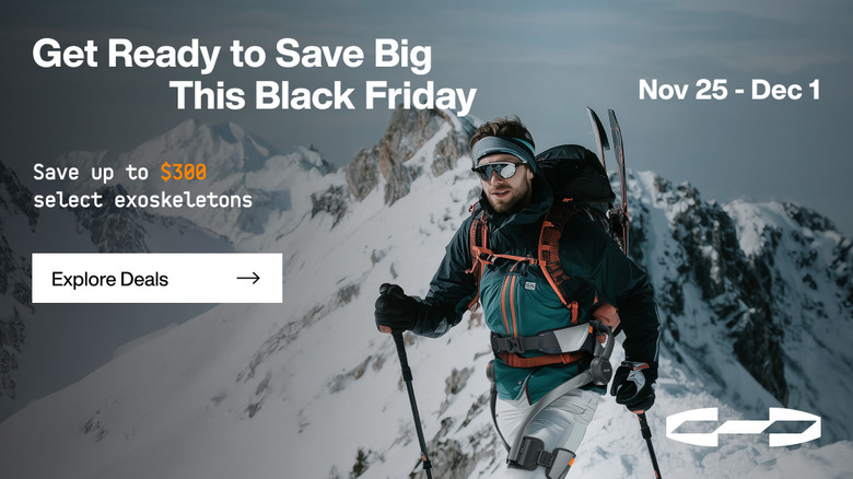 Backpacker wearing Hypershell Exoskeleton while walking in mountainous region