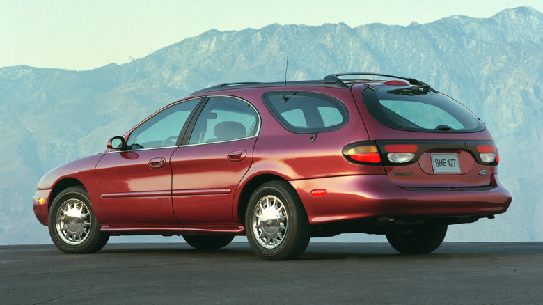 Rear 3/4 view of red 1996 Ford Taurus wagon in mountain setting