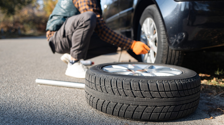 Person changing a car tire