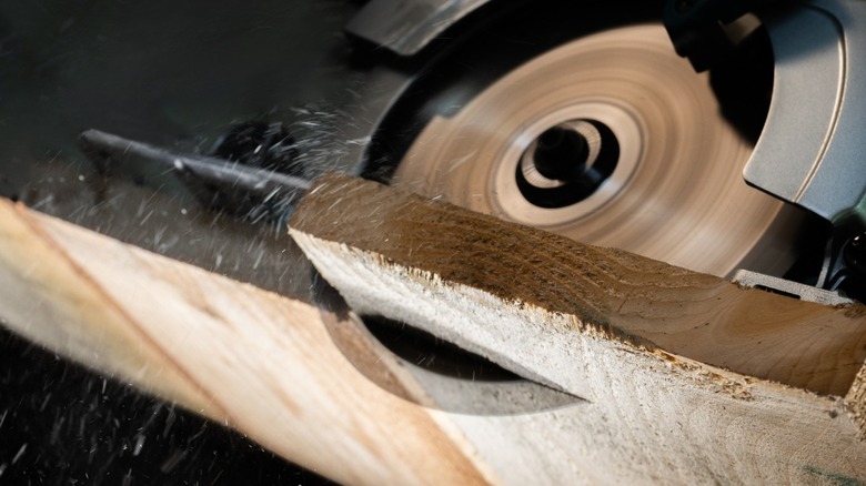 Close-up of circular saw cutting wood