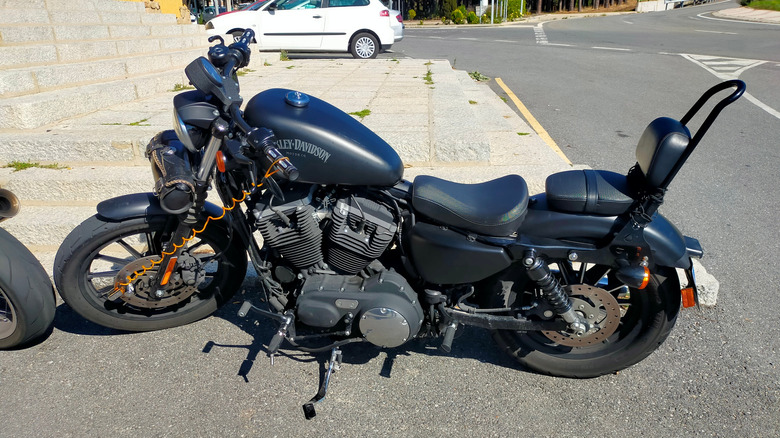 Black Harley Davidson 883 Iron parked on a street