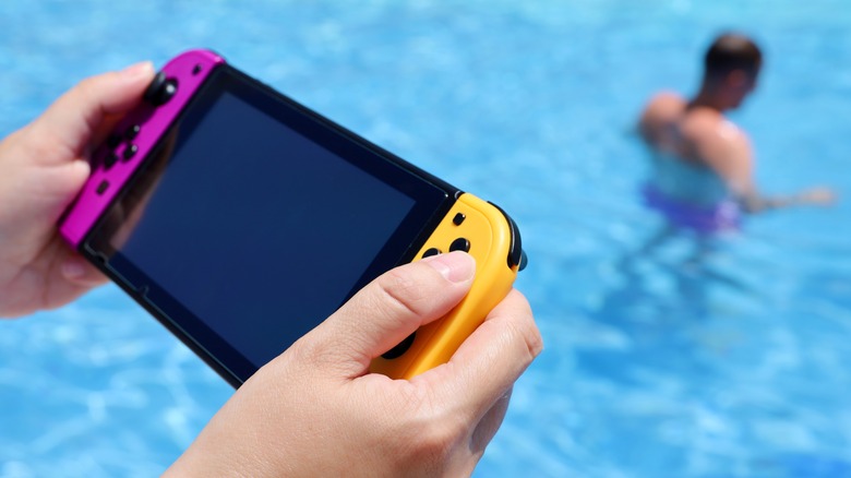 Nintendo Switch handheld by pool