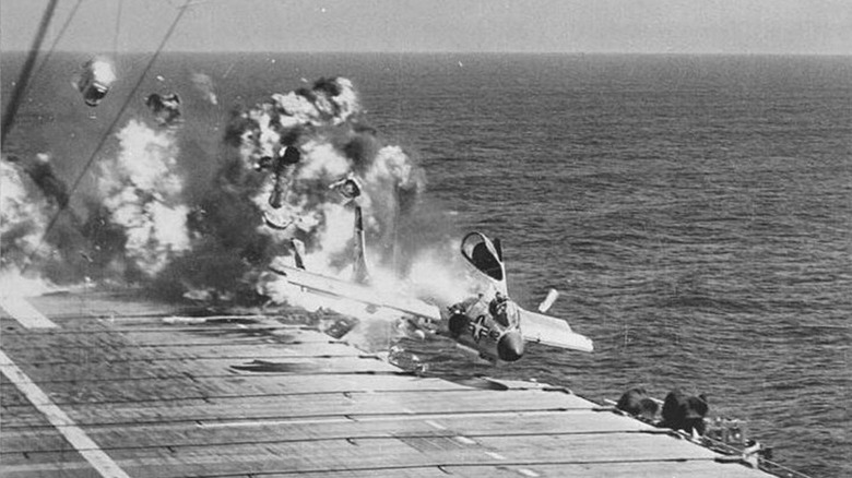 An F7U Cutlass exploding on an aircraft carrier deck after a filed landing
