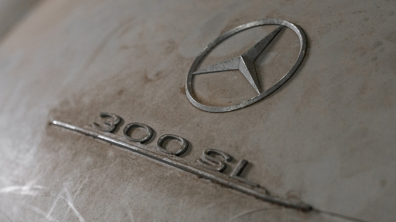 Close up of a dusty Mercedes-Benz 300 SL badge