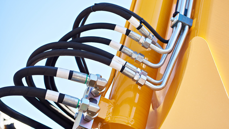 A closeup of hydraulic hoses on a piece of big machinery
