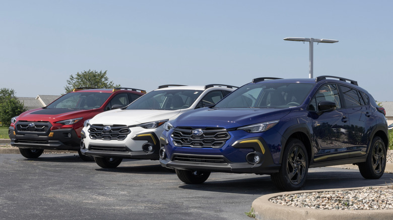 Three Subaru Crosstrek models—in red, white, and blue—on display.