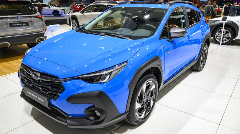 A blue Subaru Crosstrek on display at an autoshow.