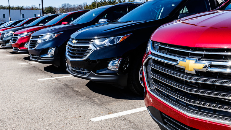 a row of chevy cars on a lot