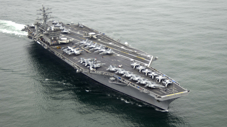 USS Nimitz with multiple aircrafts sailing in the sea