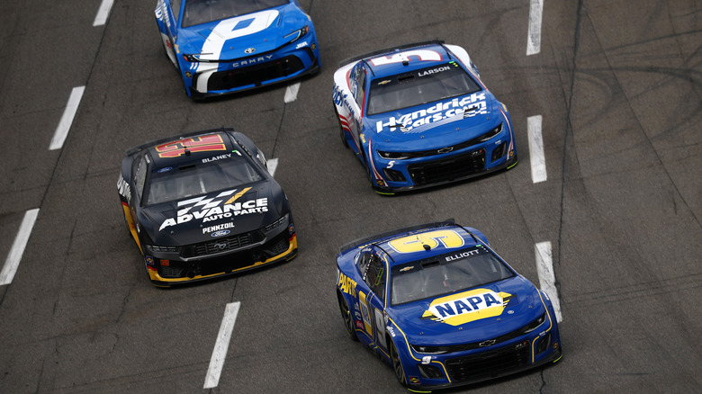 Chase Elliott, Ryan Blaney, Kyle Larson, and Denny Hamlin race down the Martinsville Speedway track during the NASCAR Cup Series Cook Out 400 in March 2025.
