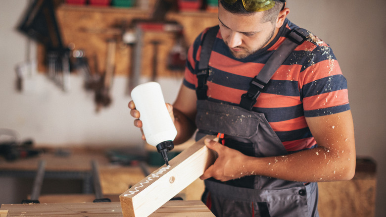 Carpenter applying wood glue
