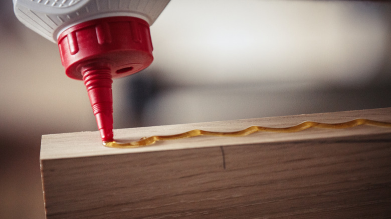 Person applying brown wood glue