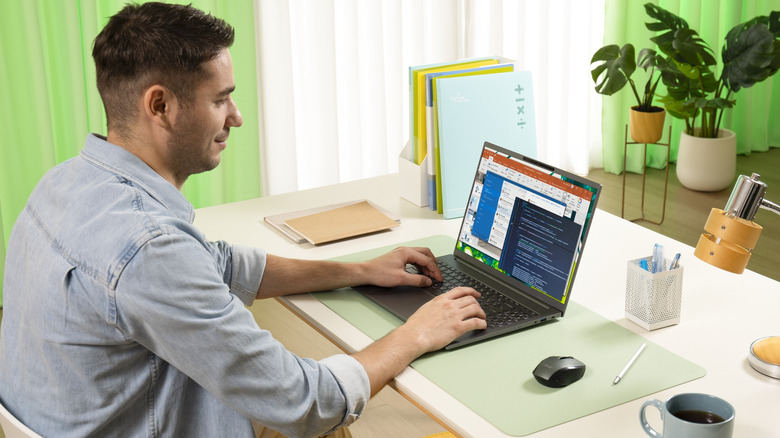 Someone using an Acer laptop in a home office.