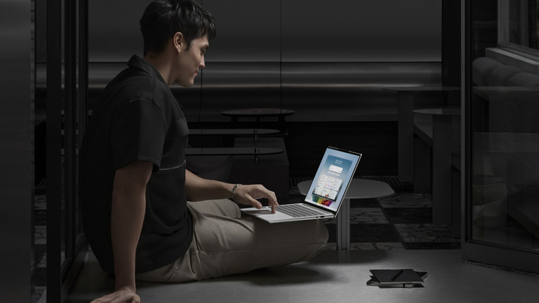 Someone using an Acer laptop on their knee.