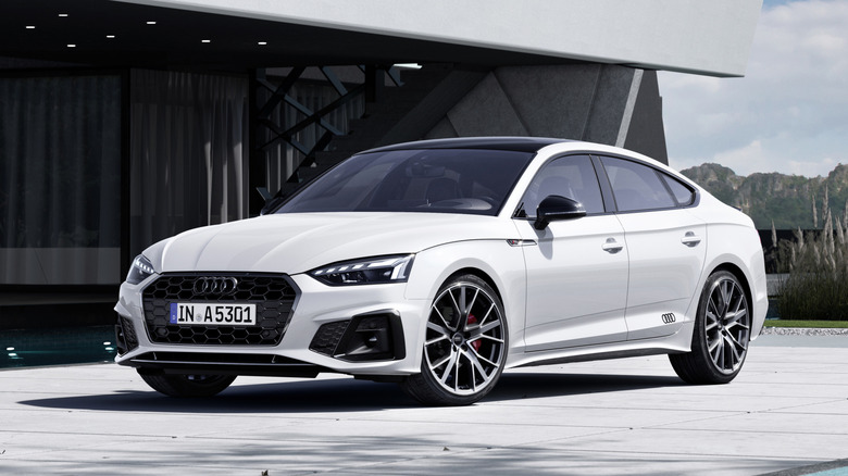 A white Audi A5 Sportback parked in front of a building