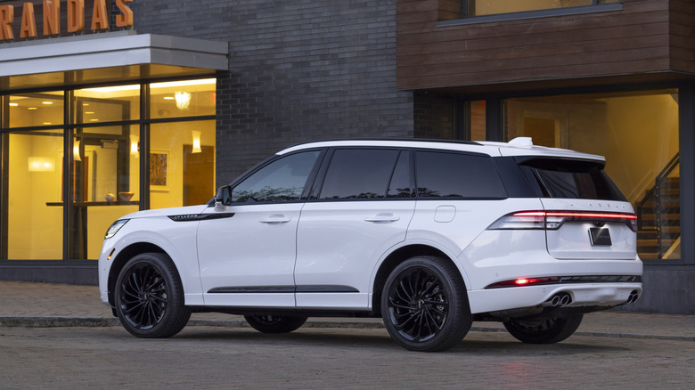 2025 Lincoln Aviator parked in front of store, rear-left view