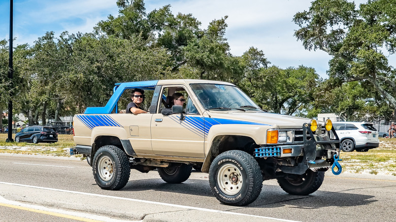 Wide front right view of tan and blue 1988 Toyota 4Runner SR5 V6 parked on roadway