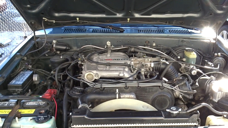 Blue 1993 Toyota pickup with hood up to show 3VZ-E V6 engine