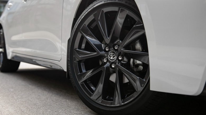 Close-up of front right wheel on a white Toyota Corolla