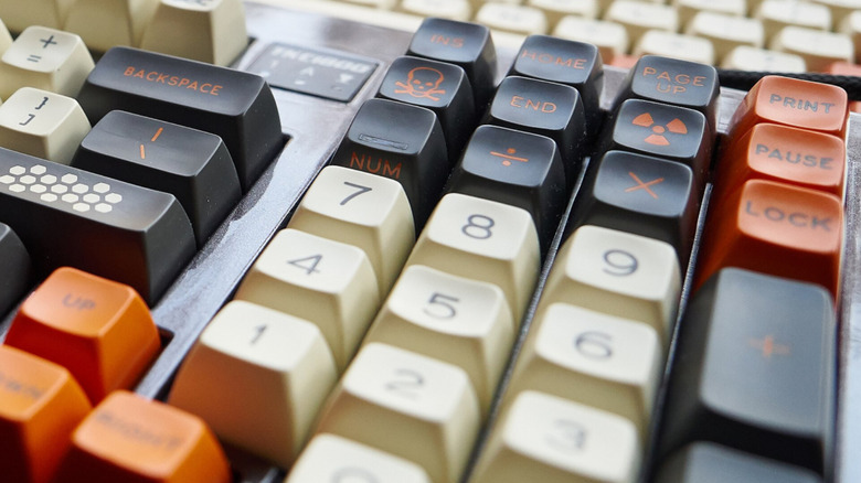 A closeup of the keypad of a customized mechanical keyboard showing the Pause button.