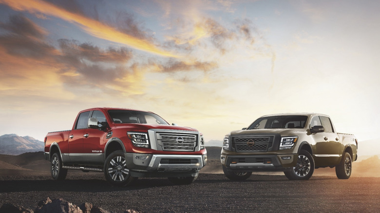 Two Nissan Titans parked at sunrise