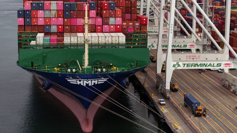 A cargo ship tethered to a dock on a gloomy day