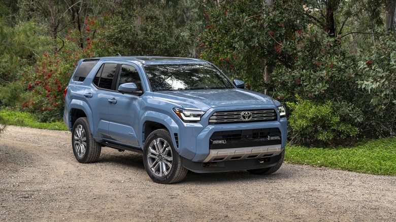 The 2025 Toyota 4Runner in blue on a gravel trail, front 3/4 view
