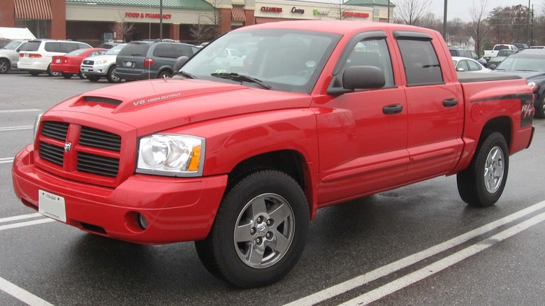 Red 2006 Dodge Dakota R/T in a strip mall parking lot