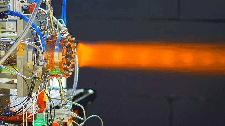 The Venus Aerospace RDRE engine during testing with a flame coming out of it.