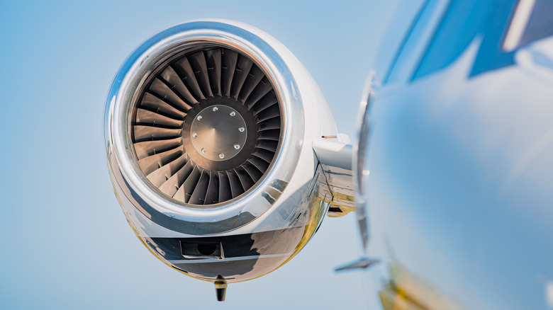 High mounted jet engine in focus with the cockpit and fuselage in soft focus