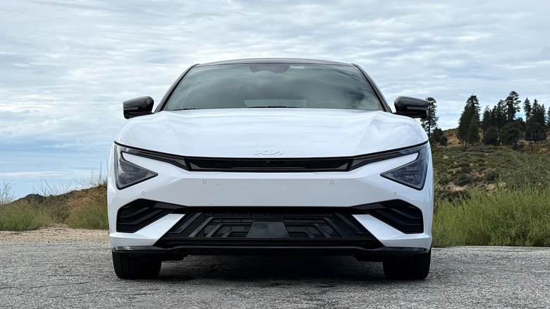 2026 Kia EV6 GT-Line front end parked in front of trees and a hillside