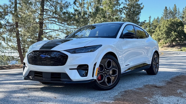 2026 Ford Mustang Mach-E GT parked in front of trees in the California mountains