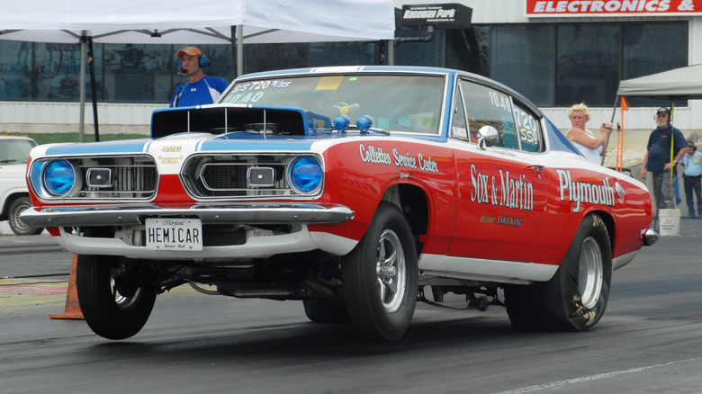 The legendary Sox & Martin Hemi Plymouth Barracuda pulls a wheelie off the start line in Englishtown, New Jersey.
