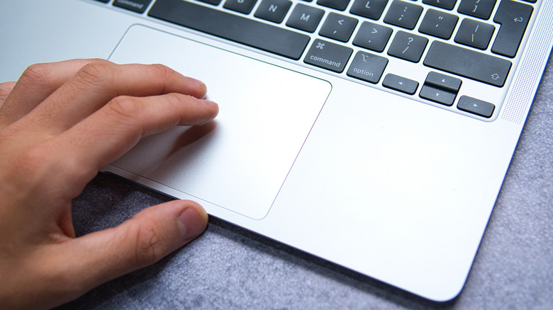 hand on macbook trackpad