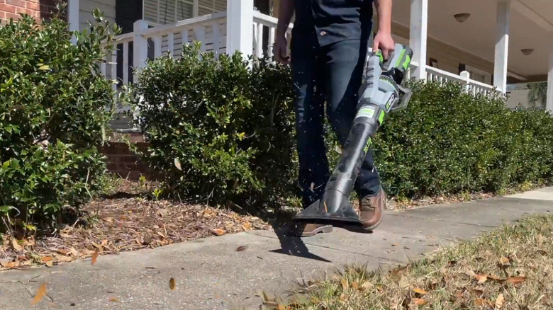EGO Power+ leaf blower being used by man on sidewalk