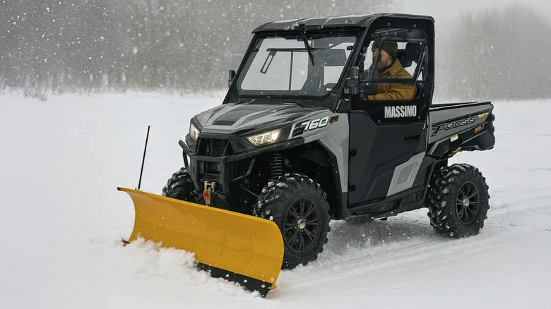 UTV with Massimo snow plow attached while driving through snow