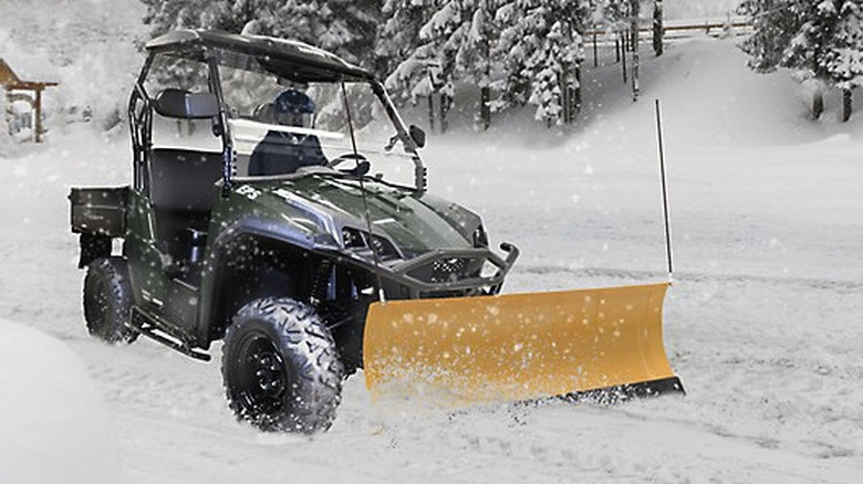 UTV with Massimo snow plow on front pushing through snow