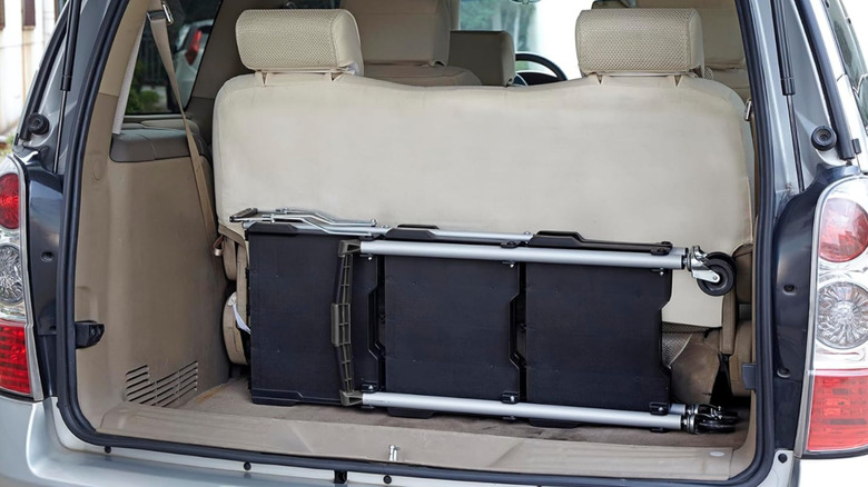 Olympia Tools Pack-N-Roll Service Cart folded in trunk of minivan