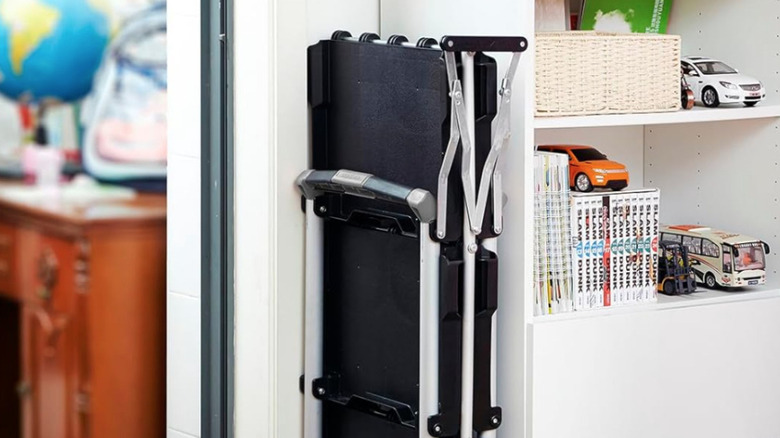 Olympia Tools Pack-N-Roll Service Cart folded against shelf