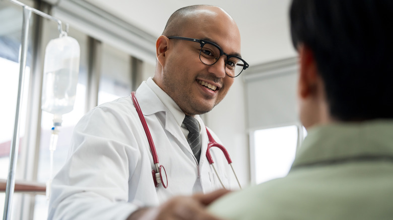 Doctor with hand on patient shoulder