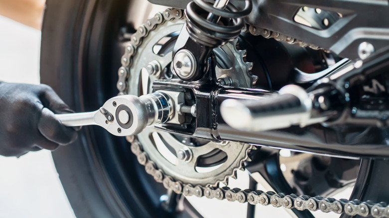 Working on motorcycle wheel