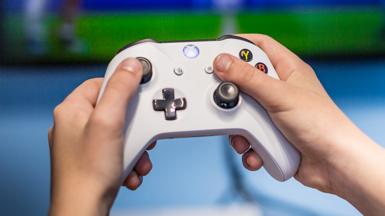 Hands holding Xbox controller