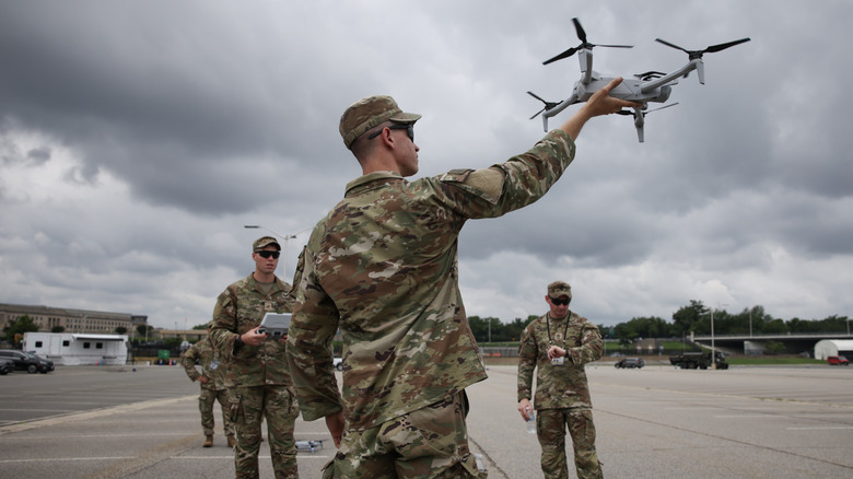 A U.S. soldier releases a drone in the Pentagon parking lot before the military parades on June 14, 2025.