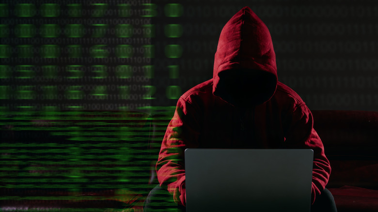 Person in hoodie using laptop